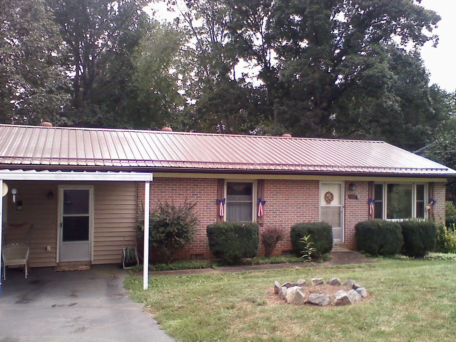 Bronze metal roof and carport on a brick ranch home — Roof Repair work by our crew in Woodbourne