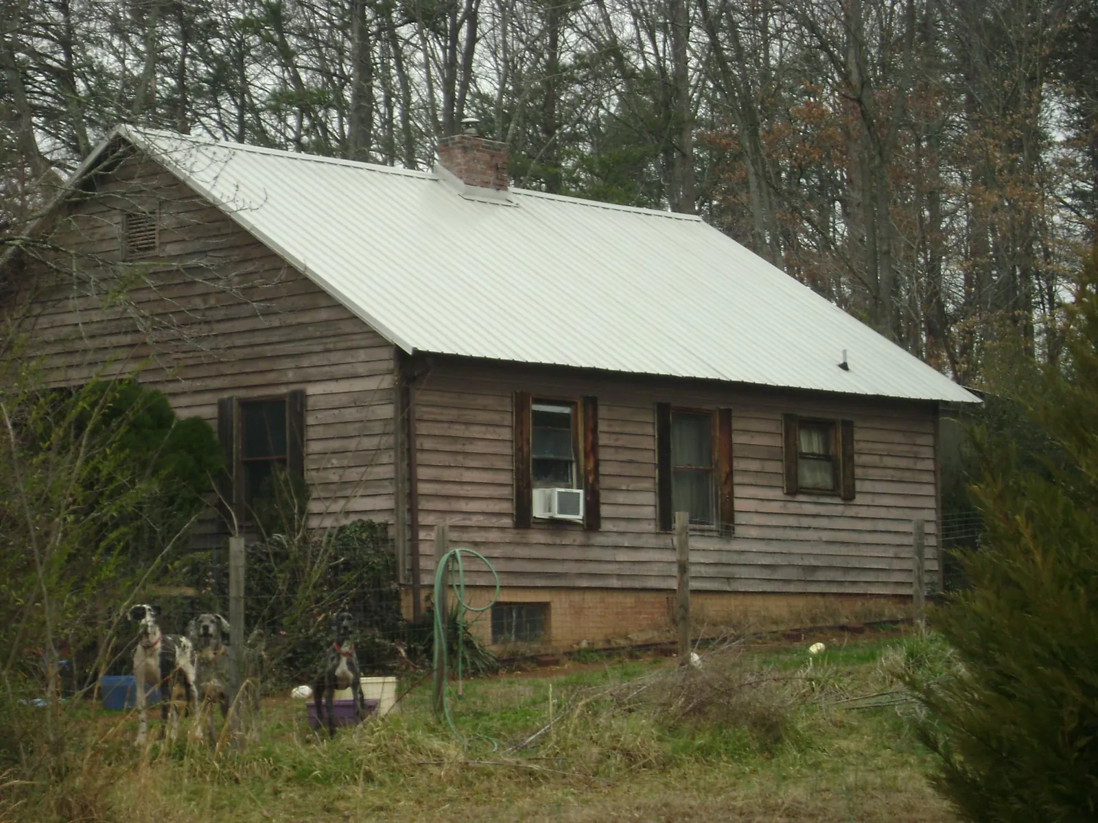 White metal roof on an old wood sided farmhouse, from a Metal Roof Installation job in Woodbourne